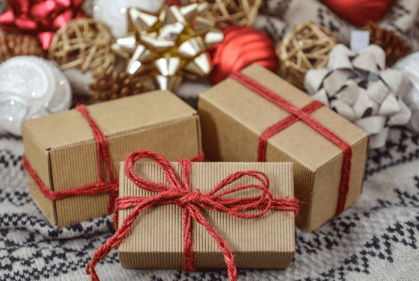 Three small packages wrapped in red ribbon.