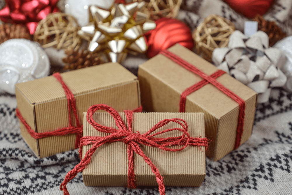 Three small packages wrapped in red ribbon.
