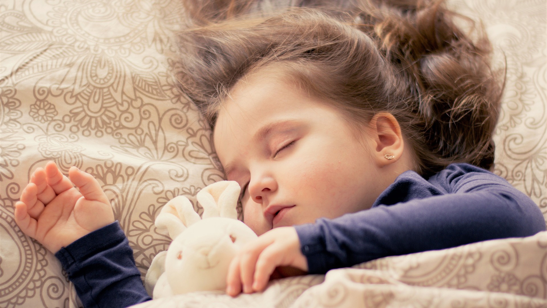 child sleeping in bed