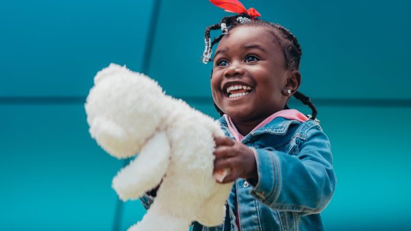 Young girl hugging a Christmas present