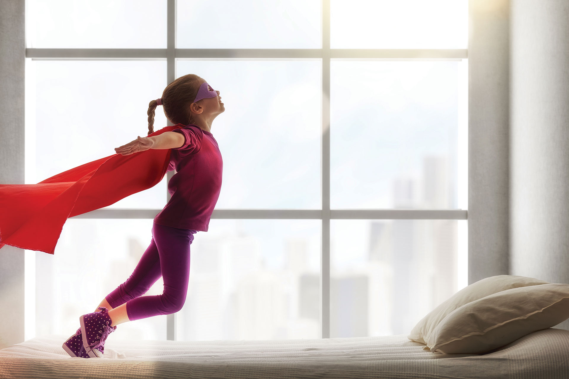 young girl in superhero costume