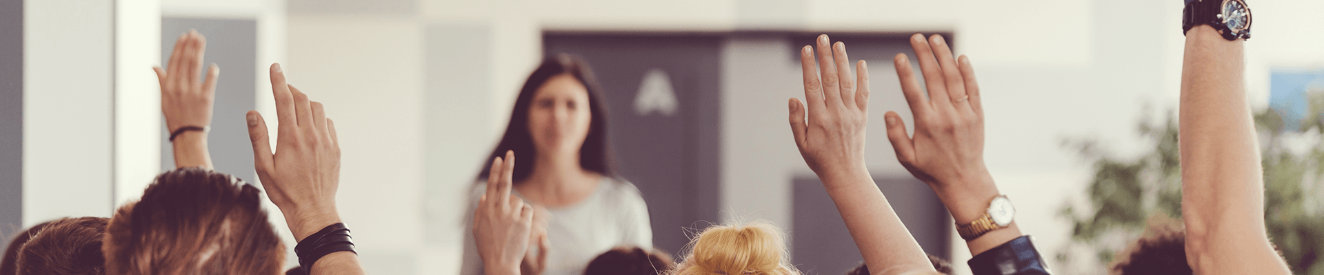 college students raising hands