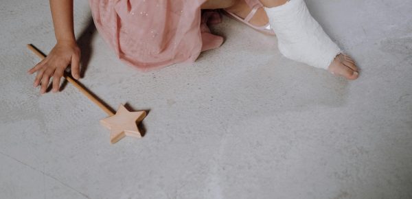 Young ballerina with her ankle in a cast